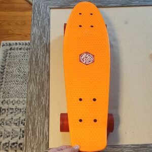Zippy Flyer Orange Skateboard.